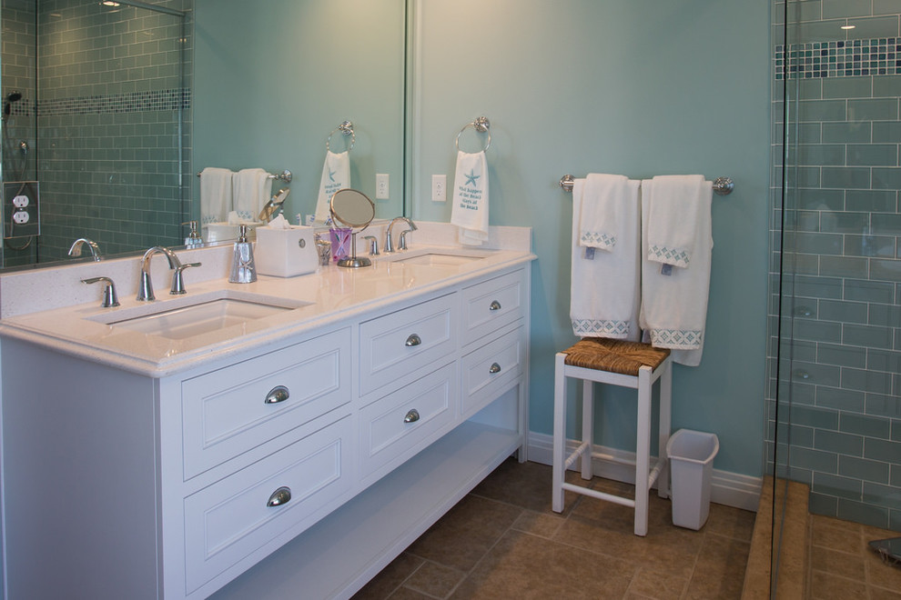 他の地域にある高級な中くらいなビーチスタイルのおしゃれなマスターバスルーム (インセット扉のキャビネット、白いキャビネット、置き型浴槽、コーナー設置型シャワー、青いタイル、セラミックタイル、青い壁、トラバーチンの床、アンダーカウンター洗面器、クオーツストーンの洗面台) の写真