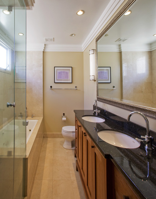 Design ideas for a medium sized classic ensuite wet room bathroom in Los Angeles with freestanding cabinets, medium wood cabinets, a built-in bath, a one-piece toilet, beige tiles, marble tiles, beige walls, marble flooring, a submerged sink, granite worktops, beige floors, a hinged door and green worktops.