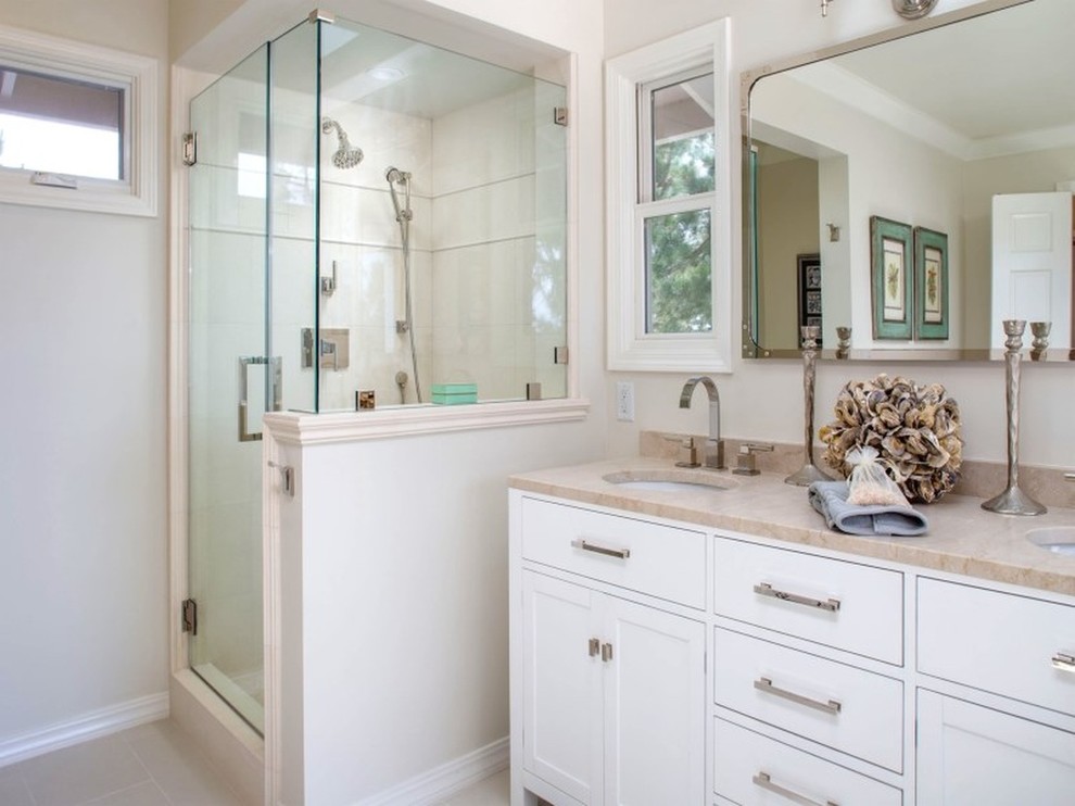 Photo of a large nautical ensuite bathroom in San Francisco with shaker cabinets, white cabinets, a freestanding bath, an alcove shower, a one-piece toilet, multi-coloured tiles, stone tiles, white walls, travertine flooring, a vessel sink and marble worktops.