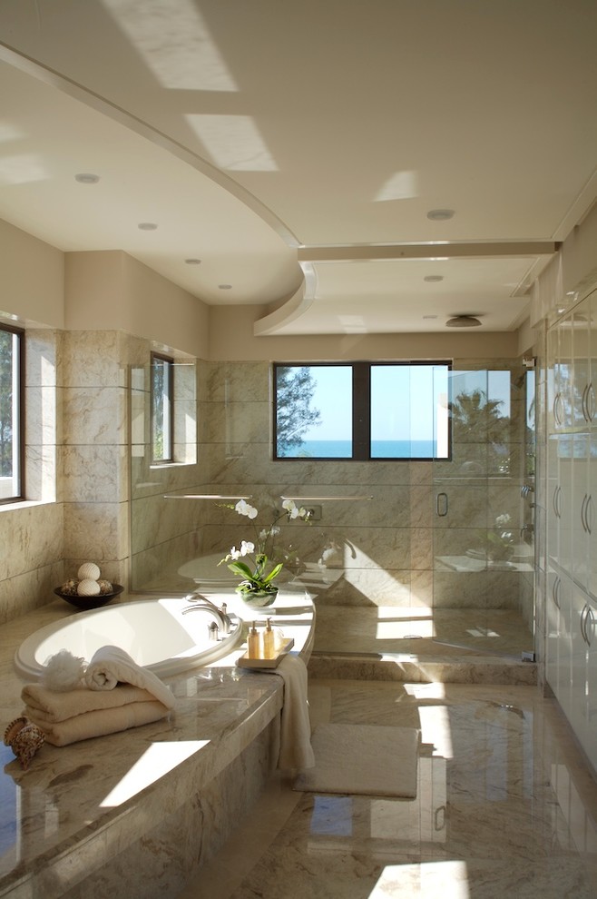 На фото: большая главная ванная комната в современном стиле с накладной ванной, душем в нише, бежевой плиткой, плоскими фасадами и белыми фасадами