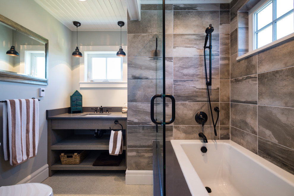 Small beach style master gray tile and porcelain tile porcelain tile and beige floor bathroom photo in Seattle with shaker cabinets, distressed cabinets, a two-piece toilet, gray walls, an undermount sink and a hinged shower door