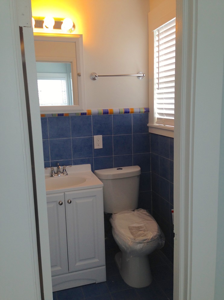 Источник вдохновения для домашнего уюта: маленькая ванная комната в стиле модернизм с монолитной раковиной, фасадами с выступающей филенкой, белыми фасадами, столешницей из искусственного камня, ванной в нише, душем над ванной, раздельным унитазом, синей плиткой, керамической плиткой, белыми стенами, полом из керамической плитки и душевой кабиной для на участке и в саду