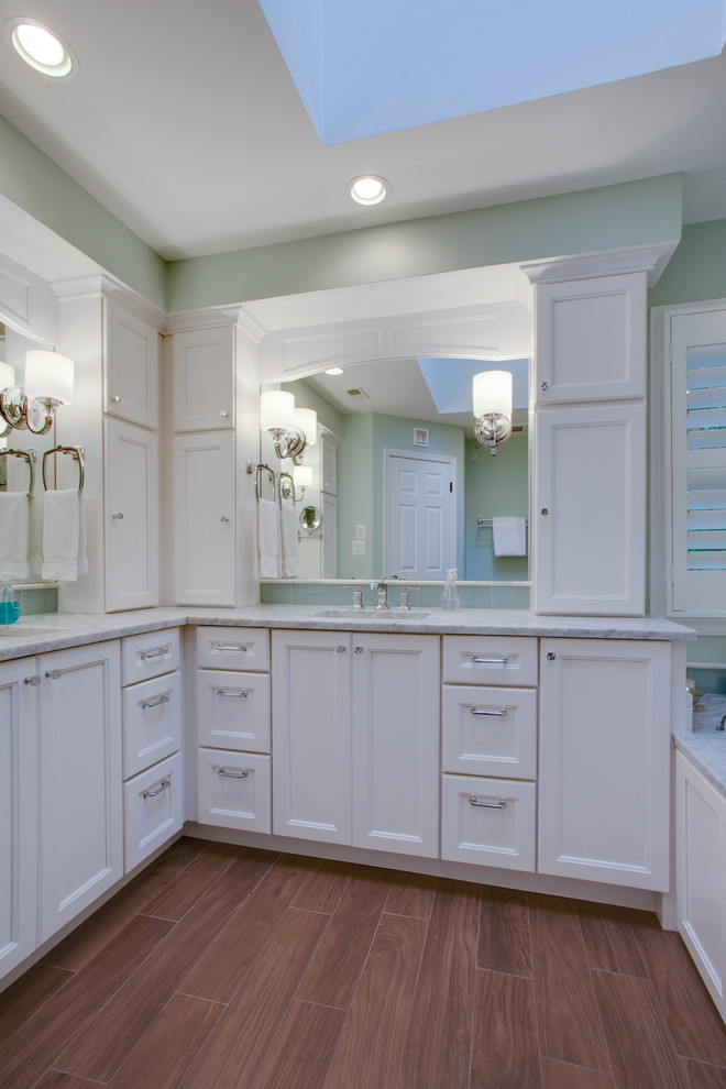 Design ideas for a medium sized contemporary ensuite bathroom in DC Metro with white cabinets, marble worktops, a corner shower, green walls, medium hardwood flooring, recessed-panel cabinets, a submerged sink and brown floors.