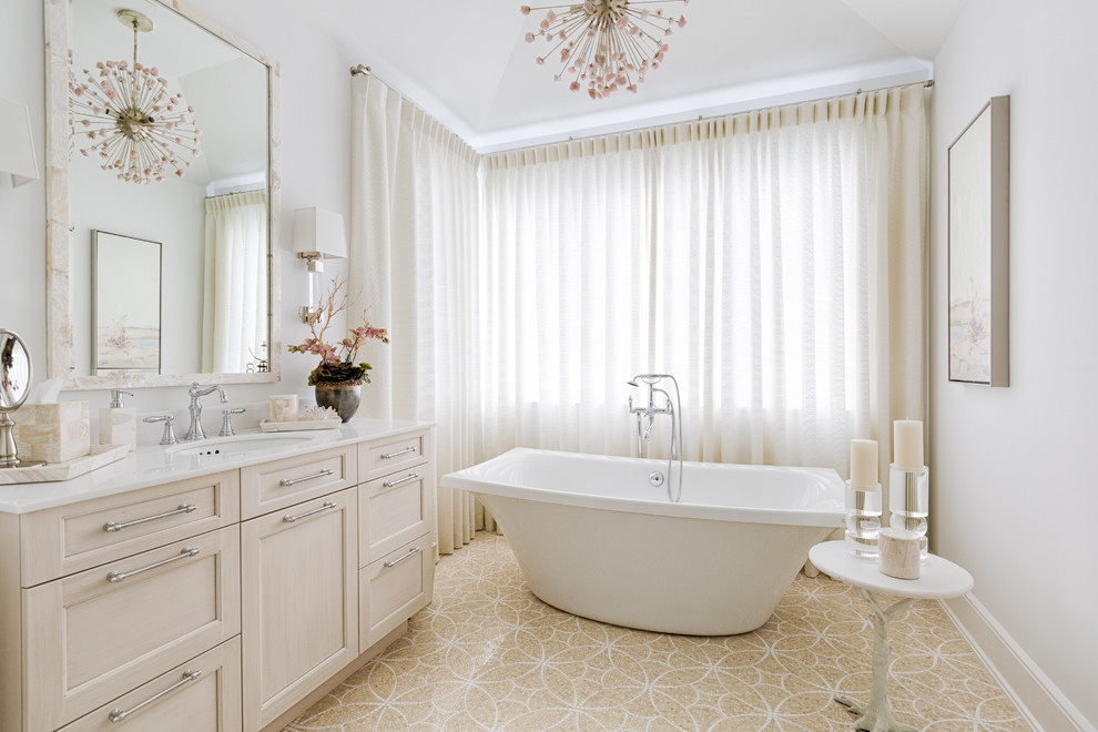 Maritimes Badezimmer En Suite mit Schrankfronten im Shaker-Stil, beigen Schränken, freistehender Badewanne, weißer Wandfarbe, Unterbauwaschbecken und beigem Boden in Miami
