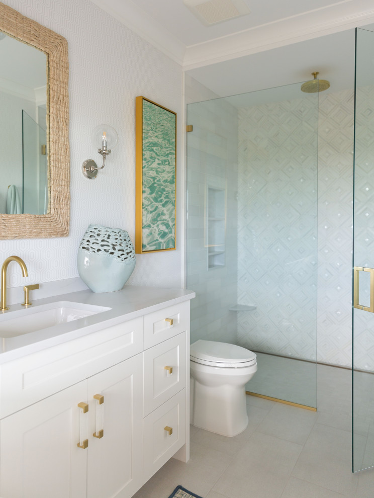 Inspiration for a beach style bathroom in Other with shaker cabinets, white cabinets, an alcove shower, white tiles, white walls, a submerged sink, grey floors, a hinged door, white worktops, a single sink and a freestanding vanity unit.