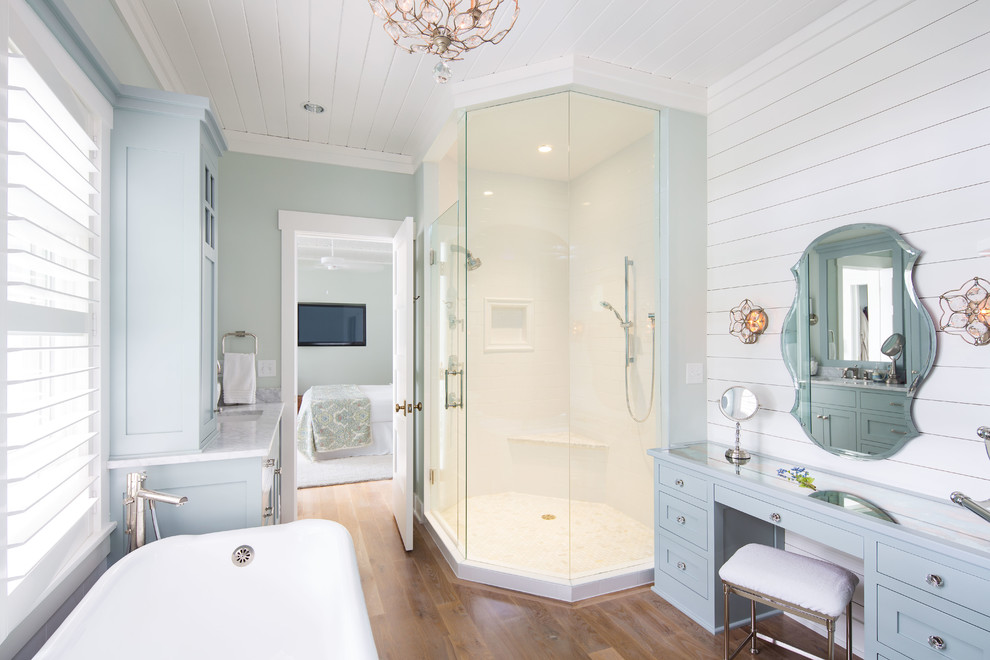 Photo of a nautical bathroom in Minneapolis with shaker cabinets, grey cabinets, a freestanding bath, a corner shower, white tiles, green walls, dark hardwood flooring, a submerged sink and a hinged door.