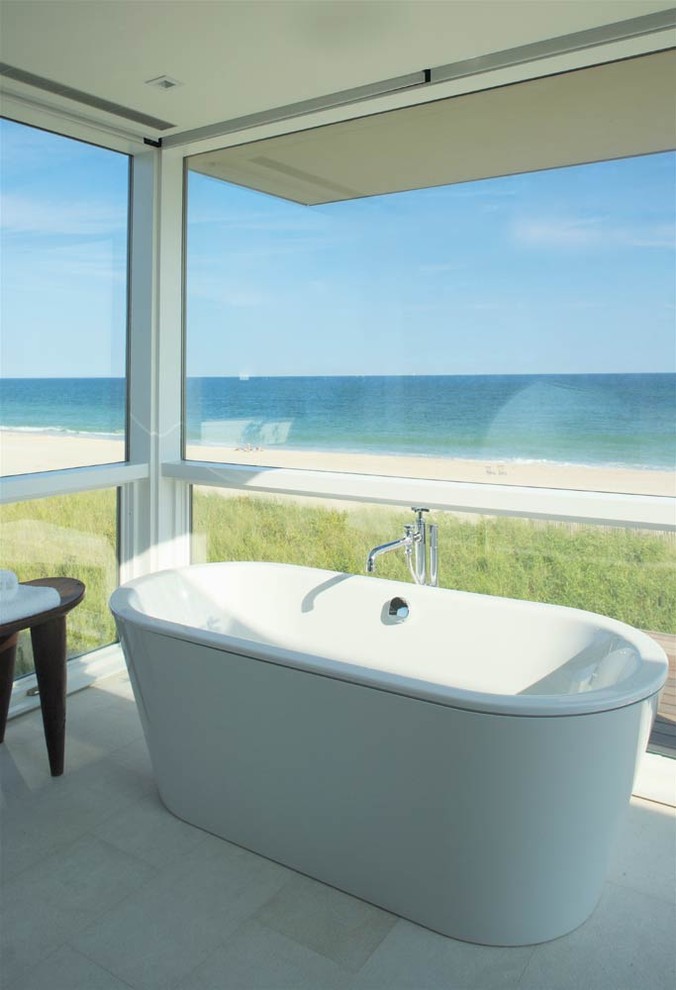 This is an example of a coastal bathroom in New York with a freestanding bath.