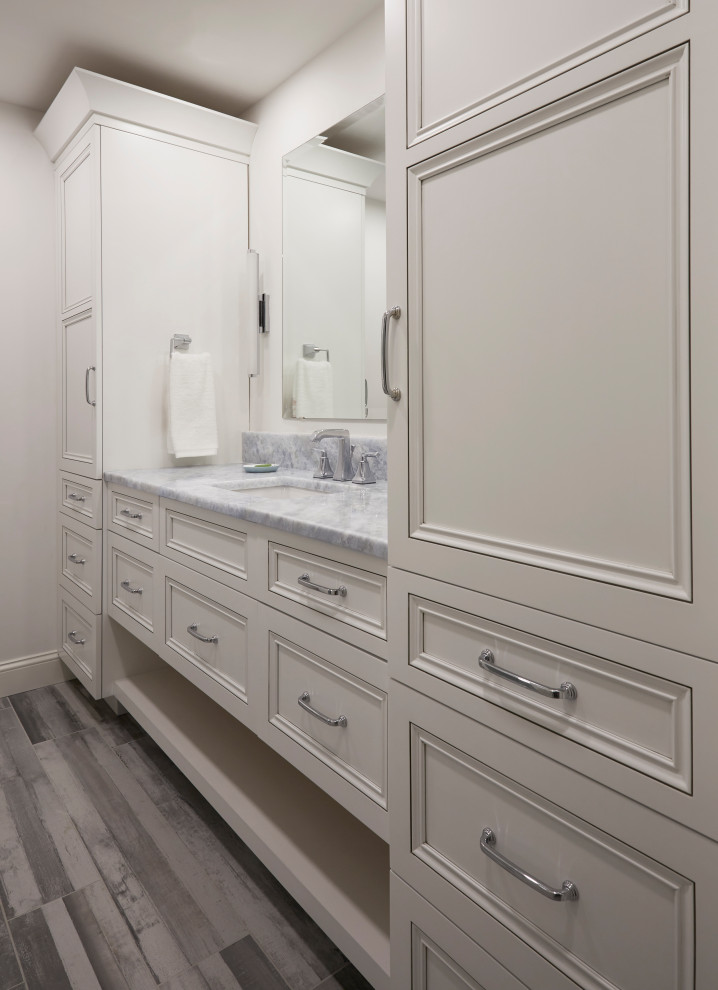 Design ideas for a small nautical family bathroom with recessed-panel cabinets, white cabinets, an alcove shower, a wall mounted toilet, blue tiles, glass tiles, grey walls, porcelain flooring, a submerged sink, marble worktops, grey floors, a sliding door, blue worktops, a wall niche, double sinks and a built in vanity unit.