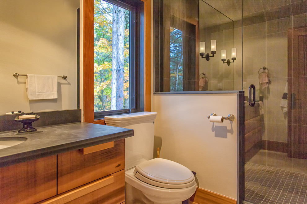 This is an example of a rustic bathroom in Toronto with a submerged sink, flat-panel cabinets, medium wood cabinets, granite worktops, grey tiles and white walls.