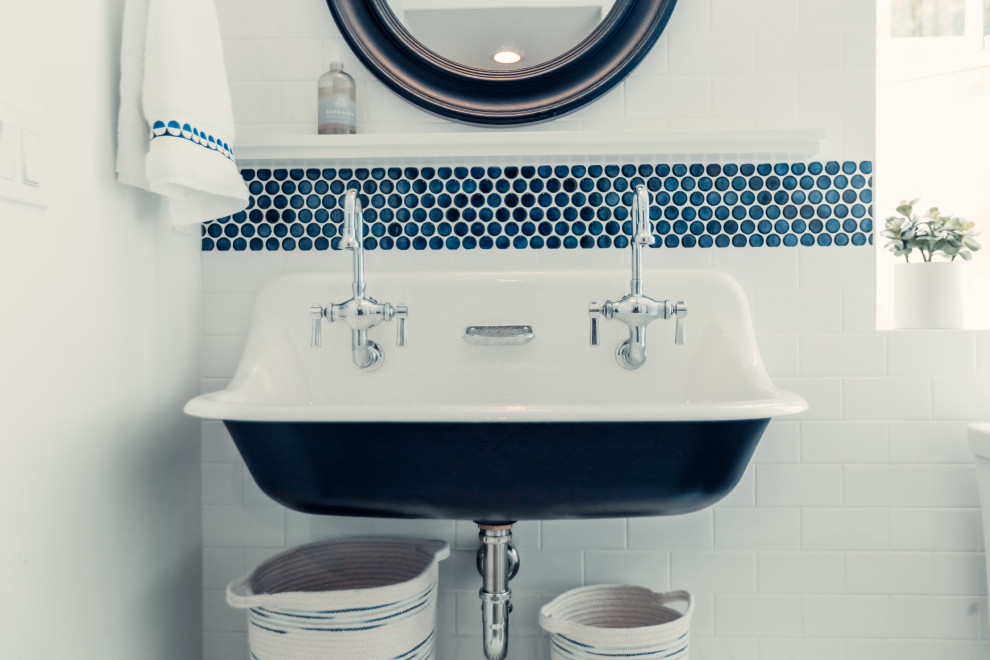 Mid-sized beach style kids' blue tile and glass tile concrete floor and single-sink bathroom photo in Other with white cabinets, a two-piece toilet, white walls, a trough sink, a hinged shower door and a floating vanity