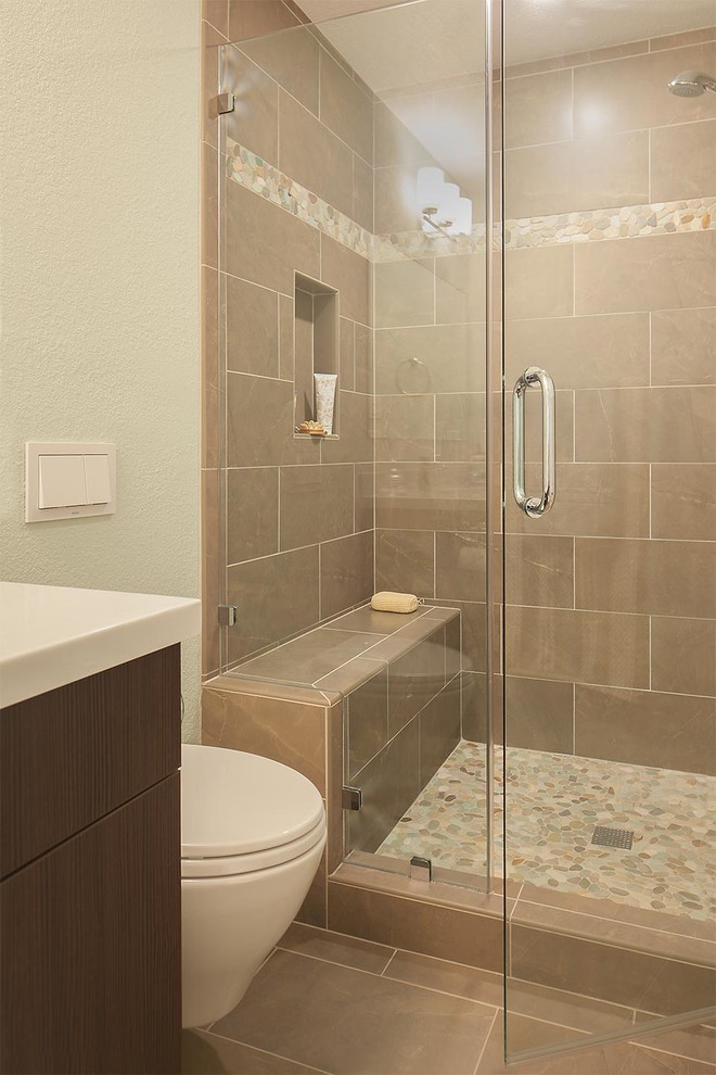 Small beach style shower room bathroom in San Francisco with a submerged sink, flat-panel cabinets, dark wood cabinets, solid surface worktops, a wall mounted toilet, grey tiles, porcelain tiles, grey walls and porcelain flooring.