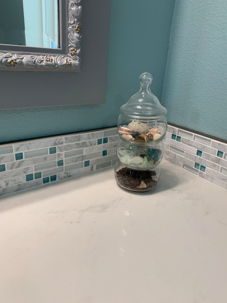 Mid-sized beach style kids' white tile and porcelain tile vinyl floor, gray floor and single-sink bathroom photo in Los Angeles with shaker cabinets, gray cabinets, a one-piece toilet, blue walls, an undermount sink, quartz countertops, white countertops, a niche and a built-in vanity