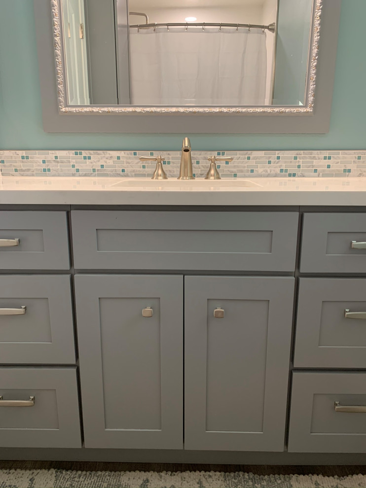 Mid-sized beach style kids' white tile and porcelain tile vinyl floor, gray floor and single-sink bathroom photo in Los Angeles with shaker cabinets, gray cabinets, a one-piece toilet, blue walls, an undermount sink, quartz countertops, white countertops, a niche and a built-in vanity
