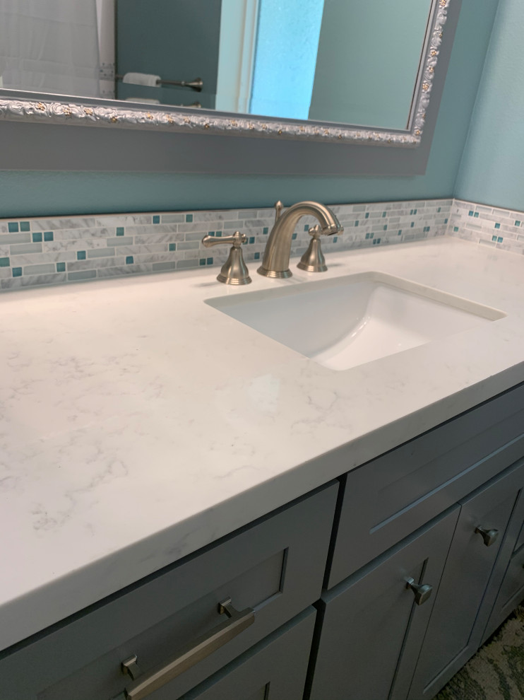 Inspiration for a mid-sized coastal kids' white tile and porcelain tile vinyl floor, gray floor and single-sink bathroom remodel in Los Angeles with shaker cabinets, gray cabinets, a one-piece toilet, blue walls, an undermount sink, quartz countertops, white countertops, a niche and a built-in vanity