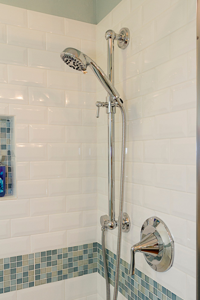 Small beach style shower room bathroom in Phoenix with shaker cabinets, white cabinets, an alcove shower, a one-piece toilet, blue tiles, metro tiles, blue walls, terracotta flooring, a submerged sink and laminate worktops.