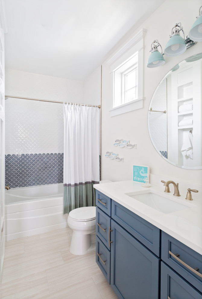 Example of a mid-sized beach style 3/4 blue tile and white tile porcelain tile and single-sink bathroom design in Tampa with shaker cabinets, blue cabinets, beige walls, an undermount sink, white countertops and a built-in vanity