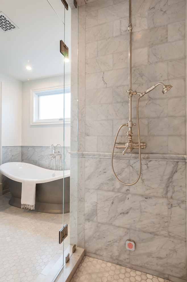 Example of a large beach style master gray tile and marble tile marble floor and white floor freestanding bathtub design in San Diego with white walls, marble countertops, a hinged shower door and white countertops