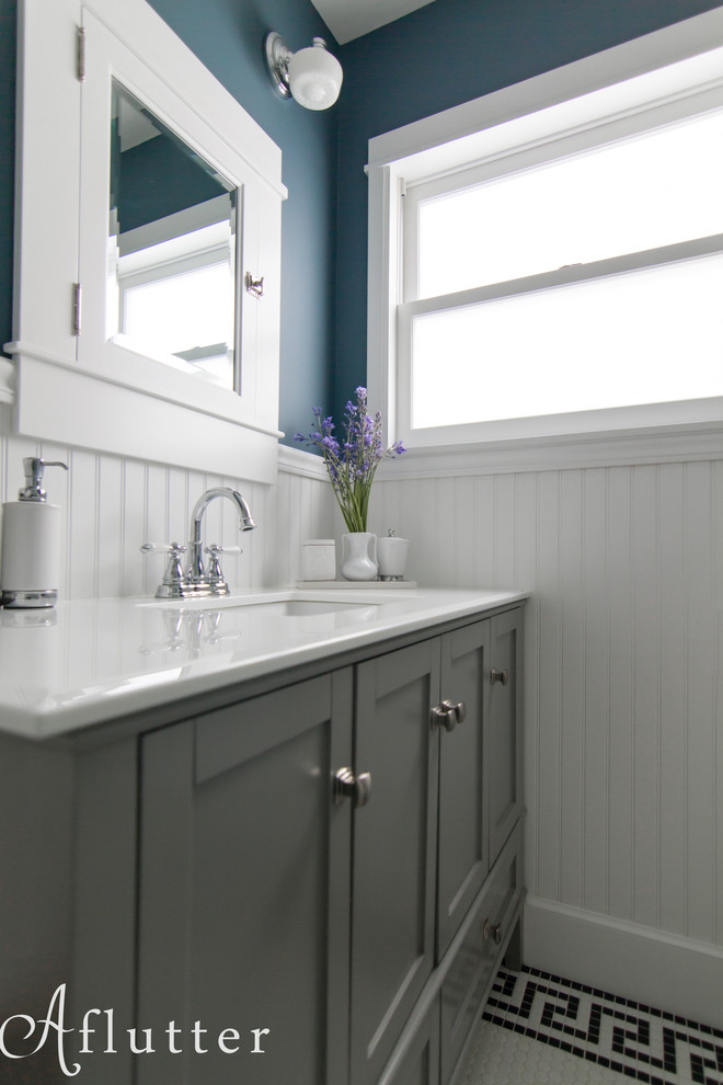 Inspiration for a small transitional white tile and ceramic tile porcelain tile bathroom remodel in Seattle with shaker cabinets, gray cabinets, solid surface countertops and blue walls