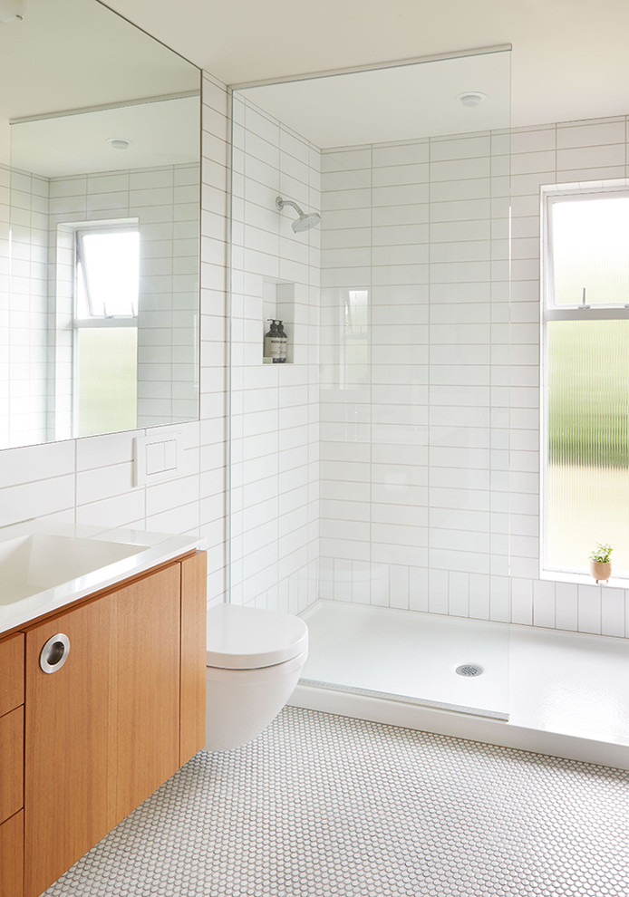 1960s white tile and ceramic tile ceramic tile and white floor bathroom photo in Seattle with flat-panel cabinets, medium tone wood cabinets, white walls, an integrated sink and quartz countertops