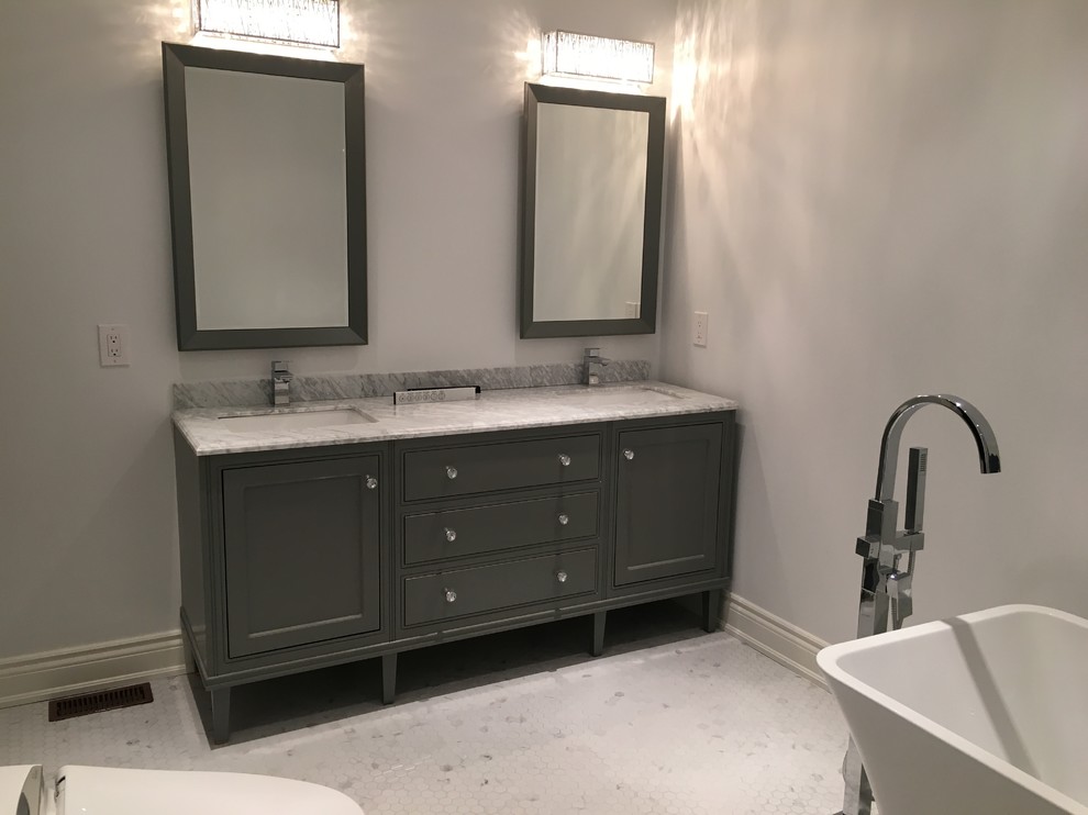 Inspiration for a mid-sized transitional master white tile and stone tile marble floor and white floor bathroom remodel in Toronto with shaker cabinets, gray cabinets, a one-piece toilet, gray walls, an undermount sink, marble countertops and a hinged shower door