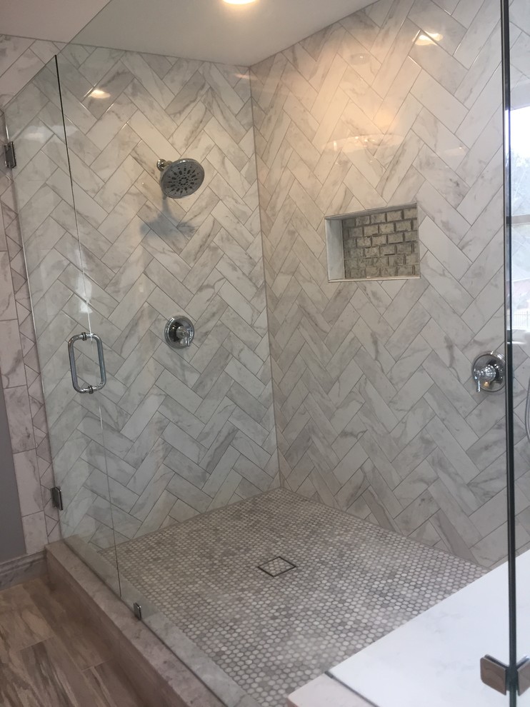 Example of a mid-sized transitional master gray tile and stone tile ceramic tile and beige floor corner shower design in Little Rock with white cabinets, gray walls, an undermount sink, a hinged shower door, recessed-panel cabinets and white countertops