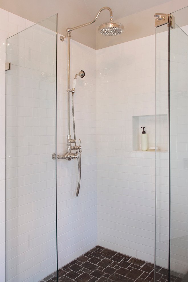 Inspiration for a rustic white tile and subway tile corner shower remodel in New York with a hinged shower door