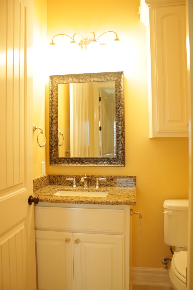 Medium sized classic family bathroom in Houston with a submerged sink, raised-panel cabinets, white cabinets, granite worktops, a corner bath, a two-piece toilet, brown tiles, porcelain tiles, yellow walls and porcelain flooring.