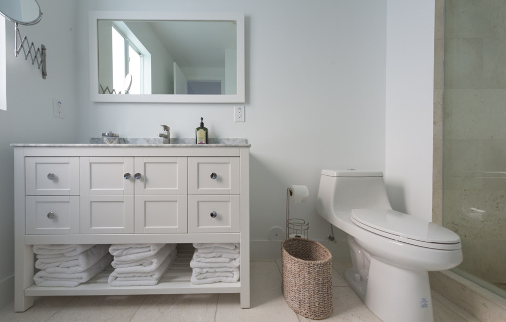 Medium sized coastal ensuite bathroom in Miami with shaker cabinets, white cabinets, an alcove shower, a one-piece toilet, white walls, ceramic flooring, a submerged sink and soapstone worktops.