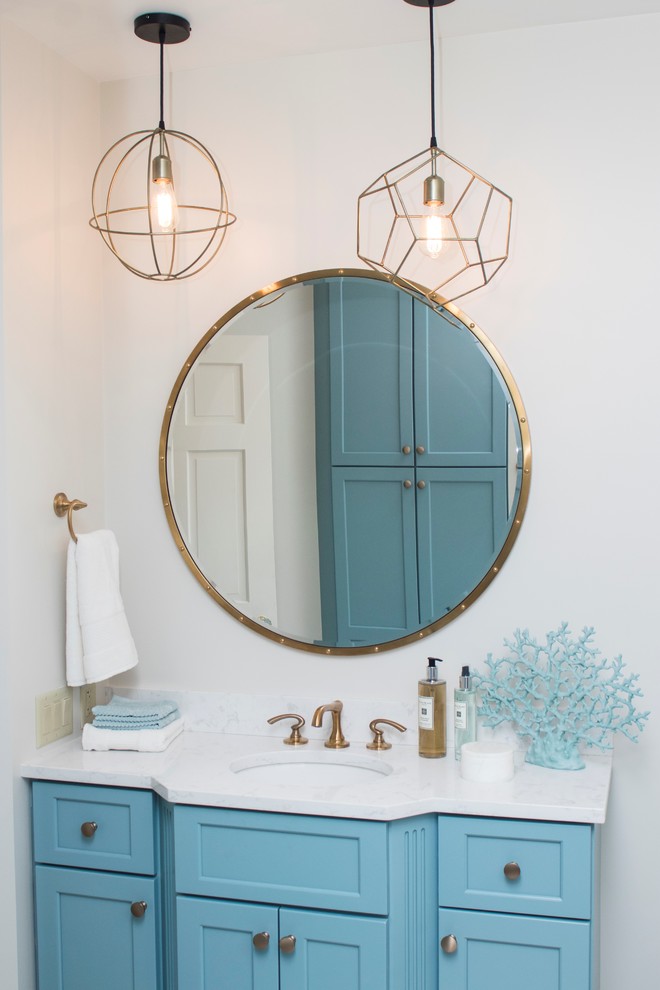 Large transitional 3/4 white tile and marble tile vinyl floor and beige floor alcove shower photo in Providence with recessed-panel cabinets, blue cabinets, a two-piece toilet, white walls, an undermount sink, marble countertops and a hinged shower door