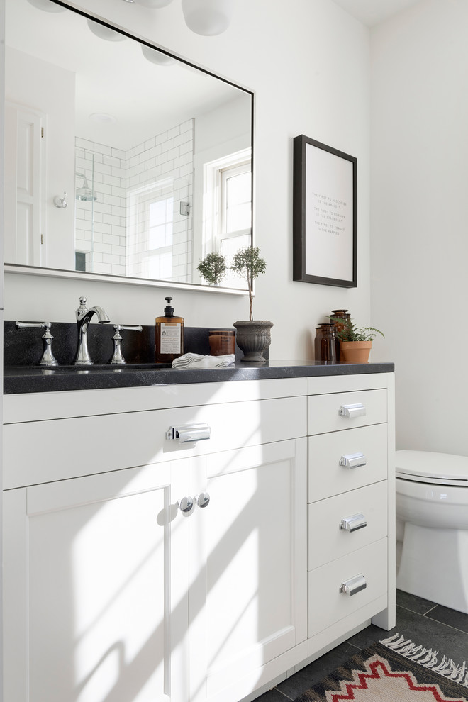 Example of a country kids' bathroom design in Minneapolis with beaded inset cabinets, white cabinets, white walls and black countertops
