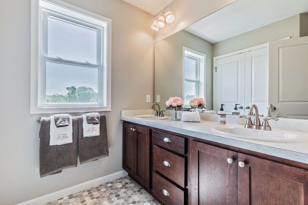 Large cottage kids' cement tile floor and multicolored floor bathroom photo in New York with shaker cabinets, dark wood cabinets, a one-piece toilet, gray walls, an undermount sink, granite countertops and gray countertops