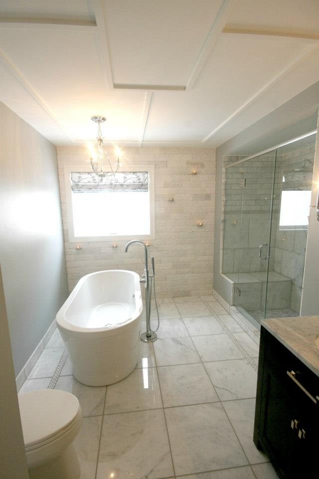 Contemporary ensuite bathroom in Other with a freestanding bath, an alcove shower, white tiles, stone tiles, white walls, marble flooring and marble worktops.