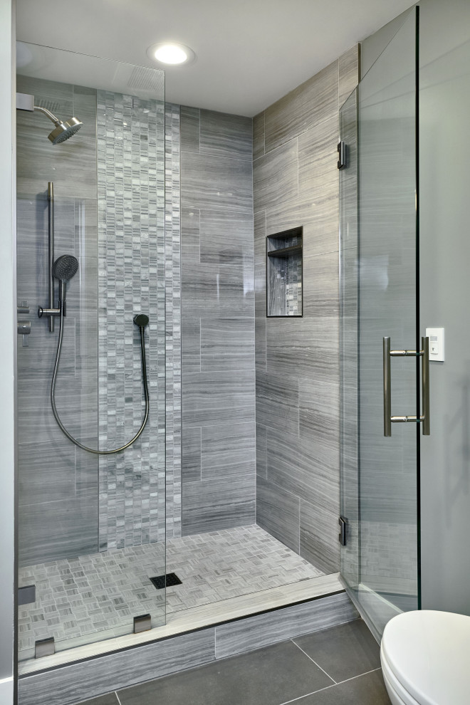 Design ideas for a medium sized contemporary family bathroom in San Francisco with flat-panel cabinets, white cabinets, an alcove shower, a one-piece toilet, grey tiles, porcelain tiles, grey walls, porcelain flooring, a submerged sink, engineered stone worktops, grey floors, a hinged door and grey worktops.
