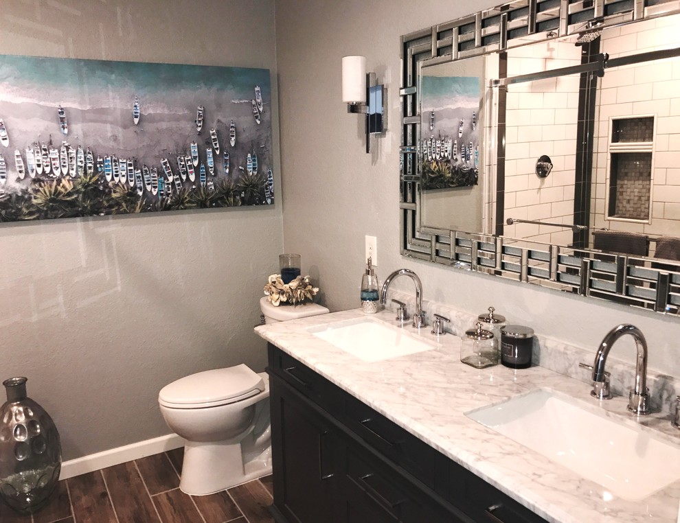 Beautiful gray vanity with marble countertop and dramatic mirror