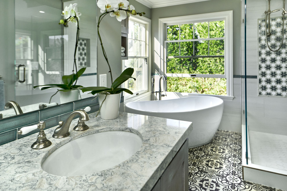 Photo of a large traditional ensuite bathroom in San Francisco with shaker cabinets, grey cabinets, a freestanding bath, a walk-in shower, a two-piece toilet, white tiles, porcelain tiles, grey walls, cement flooring, a submerged sink, engineered stone worktops, grey floors, an open shower, green worktops, double sinks and a built in vanity unit.