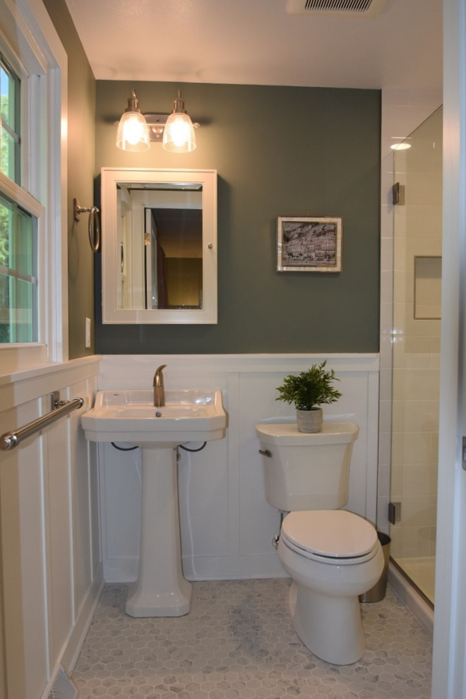 This is an example of a small traditional shower room bathroom in Other with an alcove shower, a one-piece toilet, white tiles, metro tiles, green walls, ceramic flooring, a pedestal sink, white floors, a hinged door, a shower bench, a single sink and wainscoting.