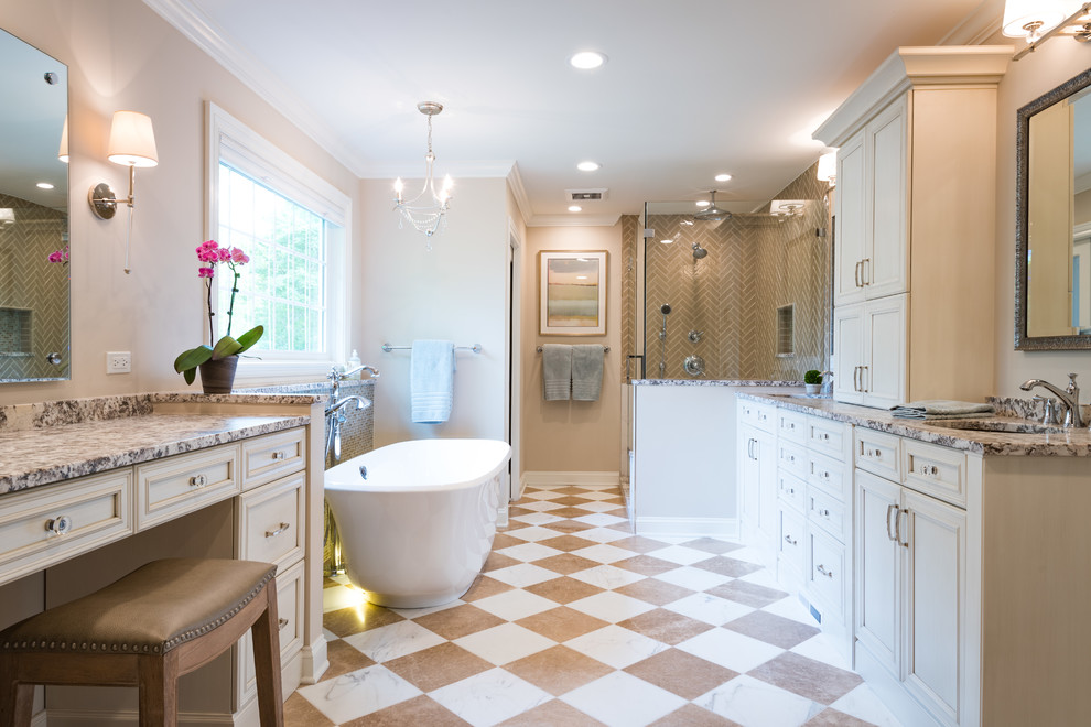 Inspiration for an expansive classic ensuite bathroom in Chicago with recessed-panel cabinets, beige cabinets, a freestanding bath, a corner shower, a one-piece toilet, black and white tiles, marble tiles, beige walls, marble flooring, a submerged sink, quartz worktops, white floors and a hinged door.