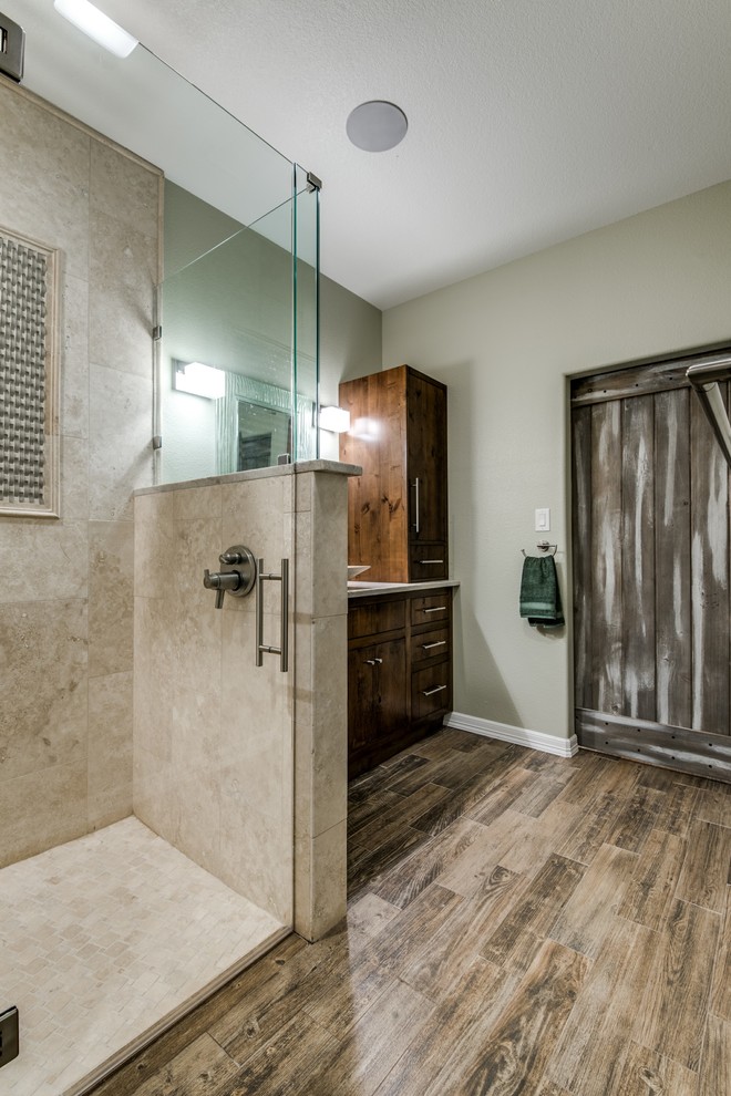 Medium sized rustic ensuite half tiled bathroom in Austin with flat-panel cabinets, medium wood cabinets, a corner shower, beige tiles, travertine tiles, beige walls, medium hardwood flooring, a vessel sink and granite worktops.