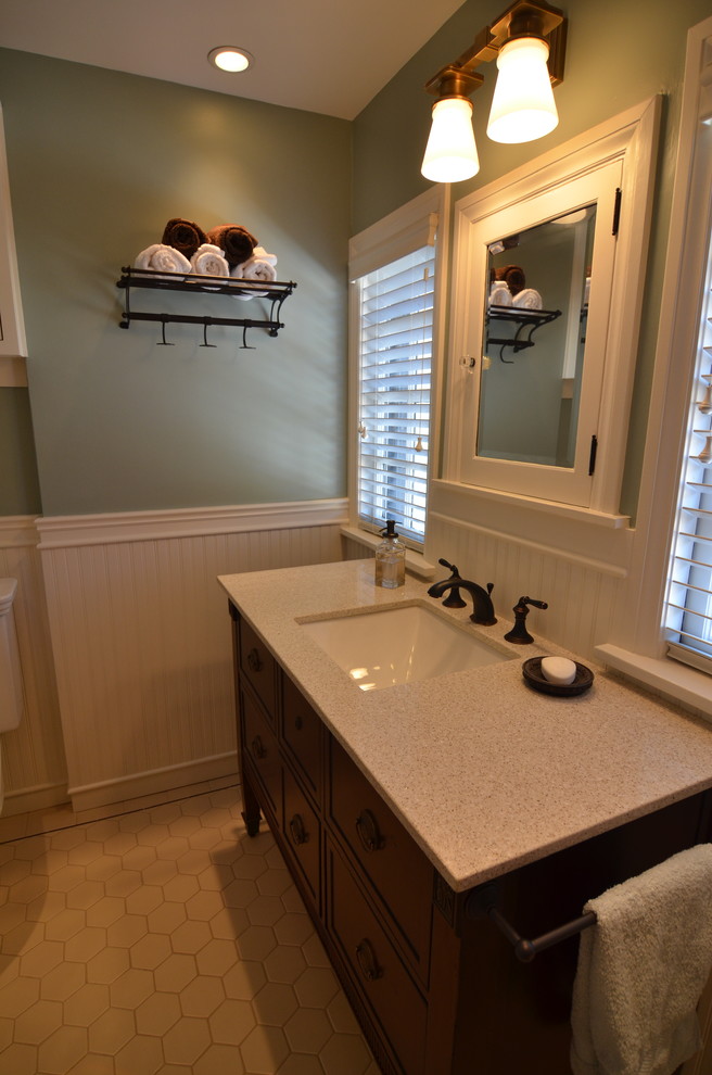 Example of a small classic beige tile and porcelain tile bathroom design in Portland with an undermount sink, furniture-like cabinets, dark wood cabinets, quartz countertops, a two-piece toilet and green walls