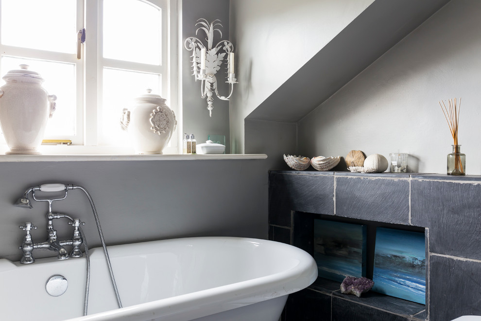 На фото: ванная комната в стиле шебби-шик с ванной на ножках и серыми стенами с