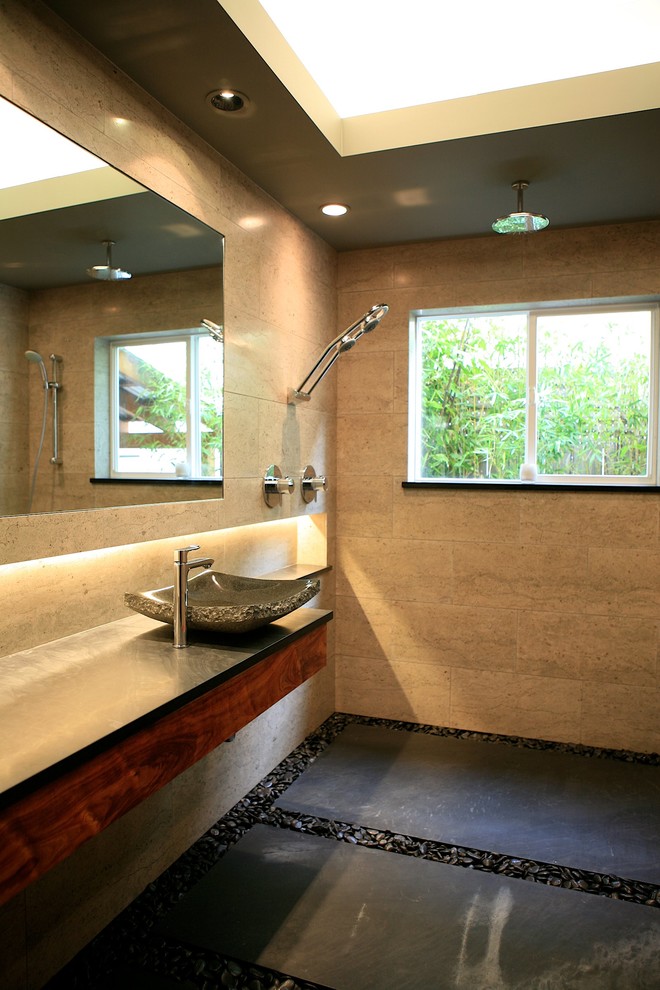 This is an example of a medium sized contemporary shower room bathroom in Other with a vessel sink, flat-panel cabinets, medium wood cabinets, soapstone worktops, a walk-in shower, grey tiles, stone tiles, grey walls and limestone flooring.