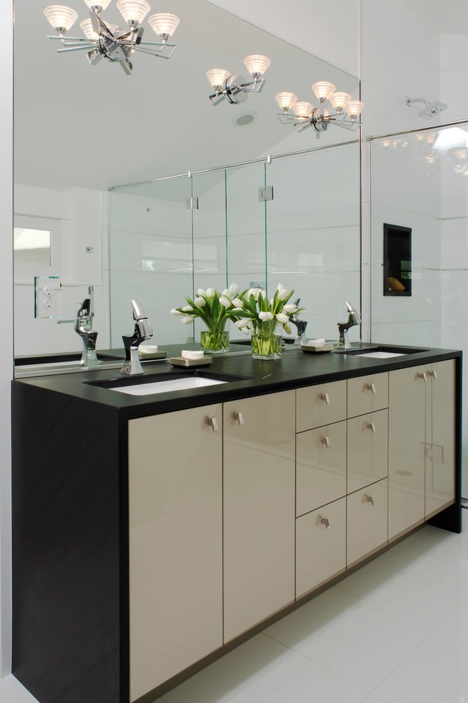 Inspiration for a contemporary bathroom in Denver with a submerged sink, flat-panel cabinets, beige cabinets, an alcove shower, white tiles, white walls, a freestanding bath and porcelain flooring.