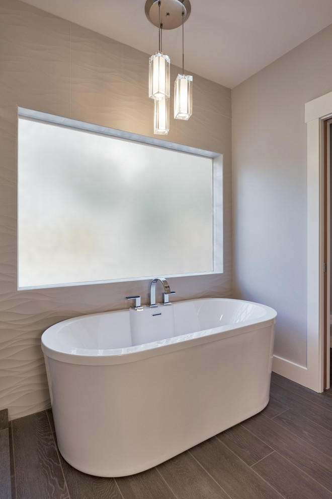 Example of a trendy master gray floor freestanding bathtub design in Seattle with white walls