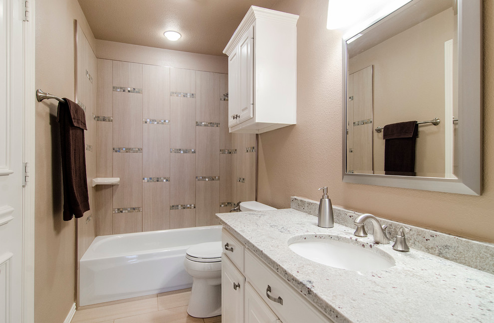Bathroom - mid-sized transitional 3/4 beige tile and ceramic tile mosaic tile floor bathroom idea in Dallas with an undermount sink, raised-panel cabinets, white cabinets, granite countertops, a one-piece toilet and beige walls