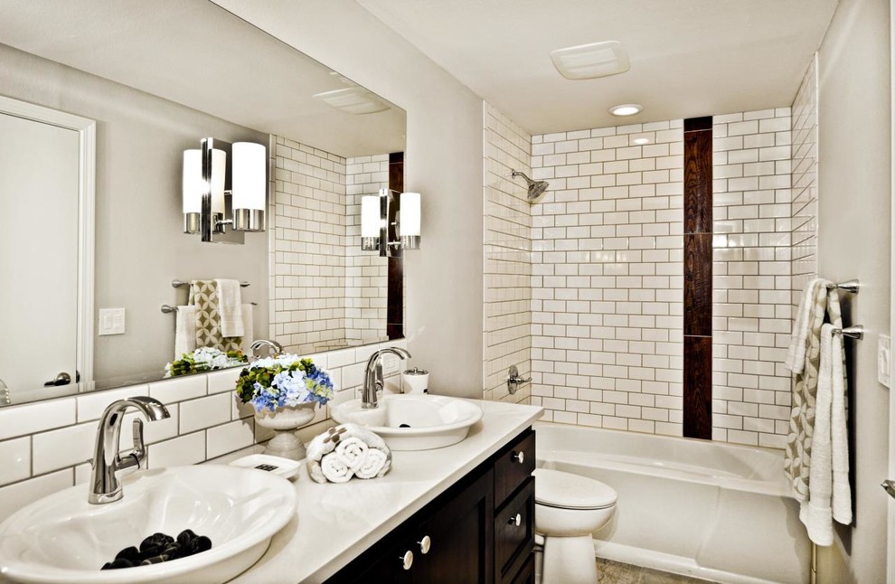 Mid-sized transitional master white tile and subway tile ceramic tile alcove bathtub photo in Boise with shaker cabinets, dark wood cabinets, a two-piece toilet, gray walls, a vessel sink and quartzite countertops