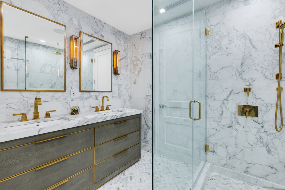 Example of a large trendy master gray tile and marble tile marble floor and gray floor wet room design in New York with flat-panel cabinets, gray cabinets, a wall-mount toilet, gray walls, an undermount sink, marble countertops, a hinged shower door and gray countertops