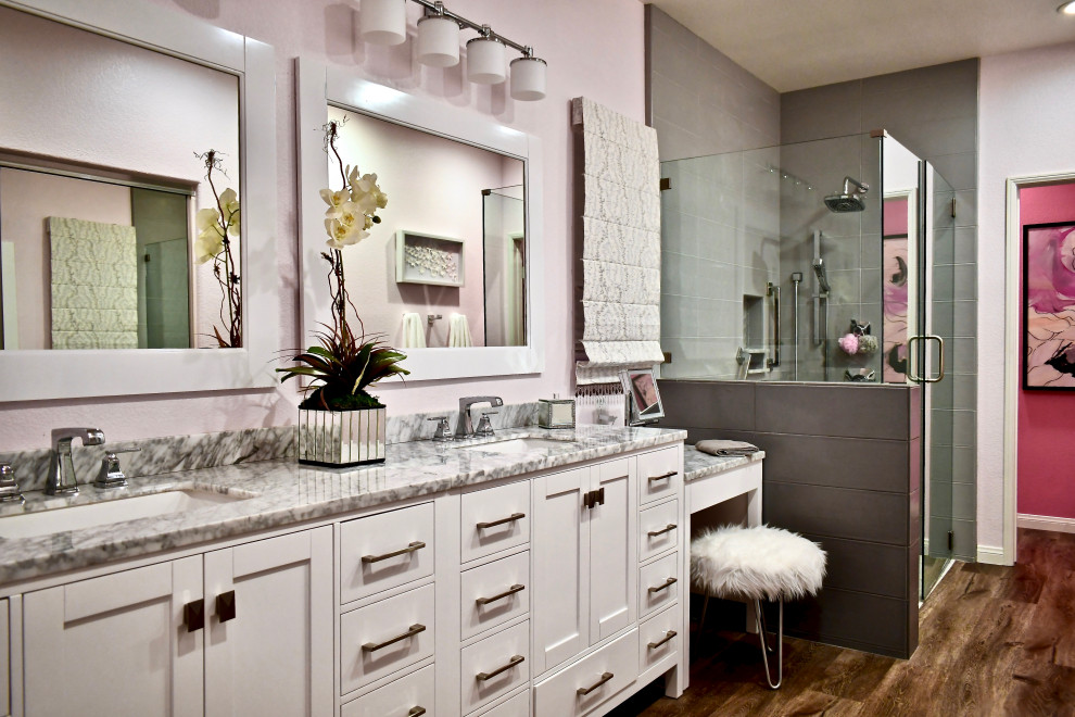 Свежая идея для дизайна: главная ванная комната среднего размера в стиле неоклассика (современная классика) с фасадами в стиле шейкер, белыми фасадами, душем без бортиков, раздельным унитазом, серой плиткой, керамогранитной плиткой, розовыми стенами, полом из винила, врезной раковиной, столешницей из кварцита, серым полом, душем с распашными дверями, серой столешницей, сиденьем для душа, тумбой под две раковины, напольной тумбой и обоями на стенах - отличное фото интерьера