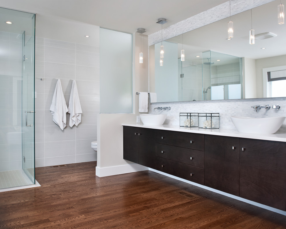 Inspiration for a modern master white tile and porcelain tile medium tone wood floor bathroom remodel in Ottawa with a vessel sink, flat-panel cabinets, dark wood cabinets, quartz countertops, a one-piece toilet and gray walls