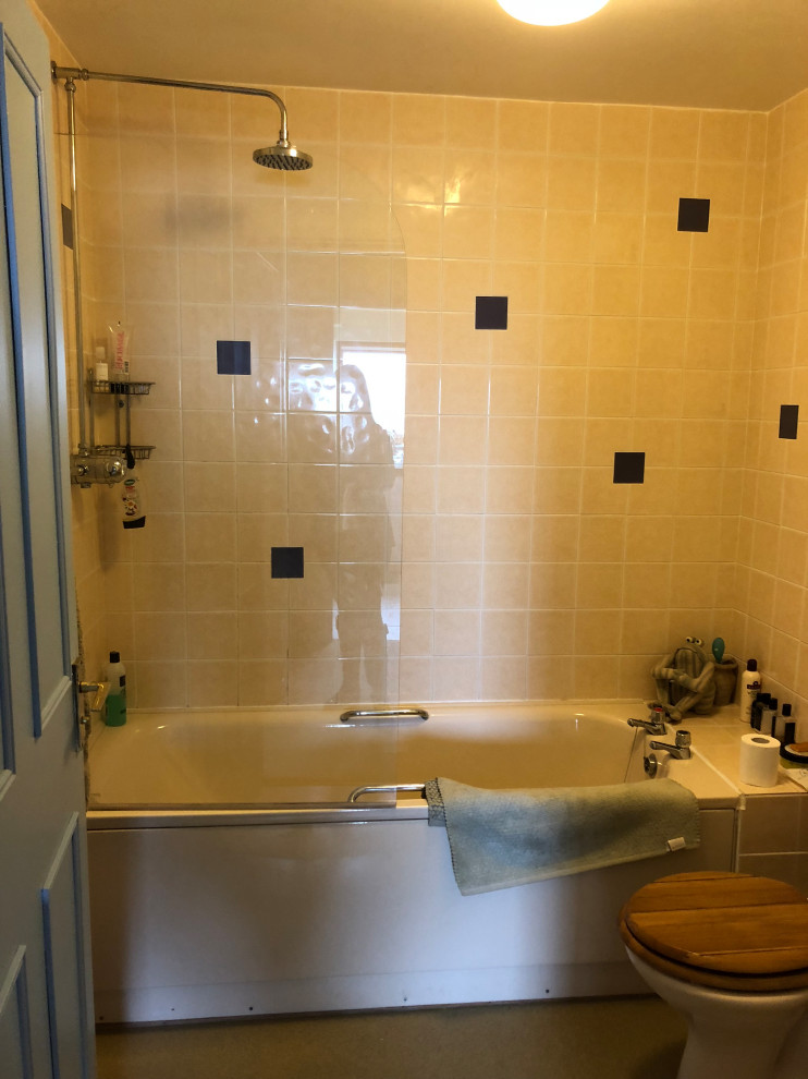 Photo of a small modern family bathroom in Other with flat-panel cabinets, blue cabinets, a built-in bath, a shower/bath combination, white tiles, ceramic tiles, granite worktops and beige worktops.