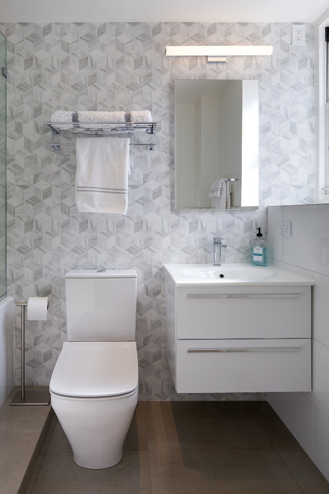 Photo of a medium sized contemporary bathroom in New York with flat-panel cabinets, engineered stone worktops, white worktops, grey tiles, white tiles, mosaic tiles, white walls, a console sink and brown floors.